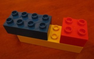 Two lego bricks mounted on top of a third brick.