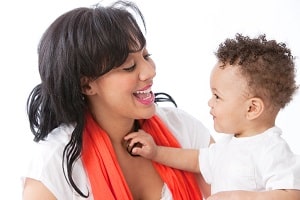 mother talking cheerfully, face-to-face, with attentive baby