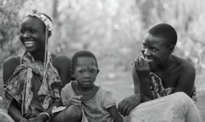 Members of the Hadza tribe, hunter-gatherers in Lake Eyasi, Tanzania, circa 2012. Mother smiling with young boy.