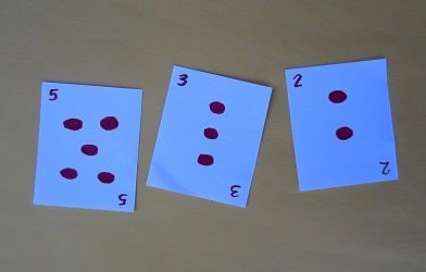 Three number cards depicting the quantities 5, 3, and 2.