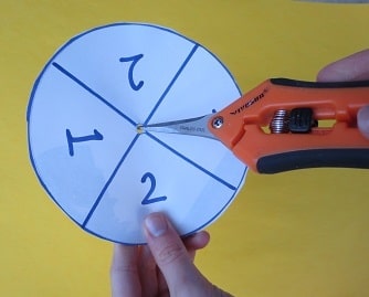 Making a spinner: punching a hole in the center with a pointy-ended tool