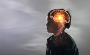 toddler in profile, eyes closed, with a view of his brain superimposed over his head