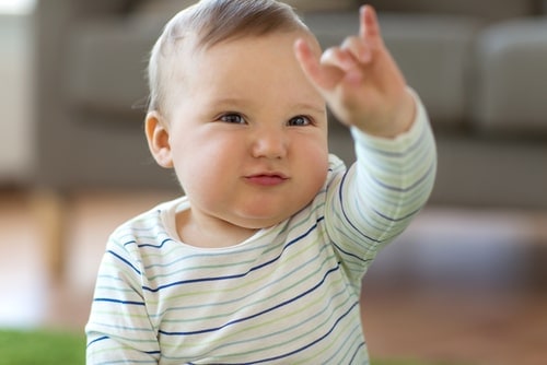 infant boy making hand gesture