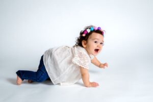 baby girl crawling on hands and knees, happy