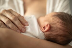 closeup sleepy baby breastfeeding or "dream feeding"
