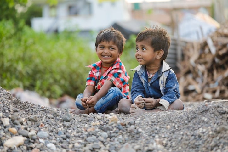 Friendship in children displayed by two cute toddlers sitting outside together