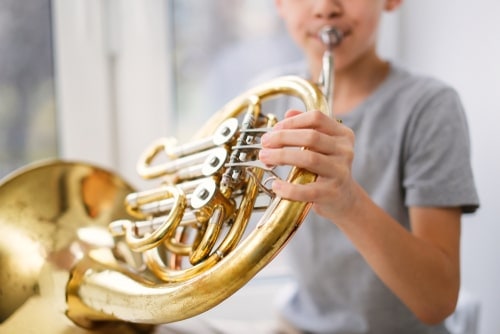 boy playing French horn