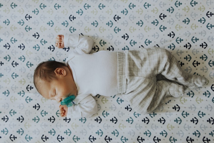 sleeping newborn with pacifier in mouth