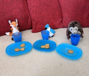 three soft toys served with plates, cups and treats