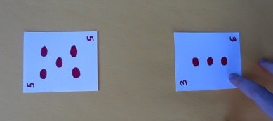 Number card featuring "5" versus number card featuring "2"