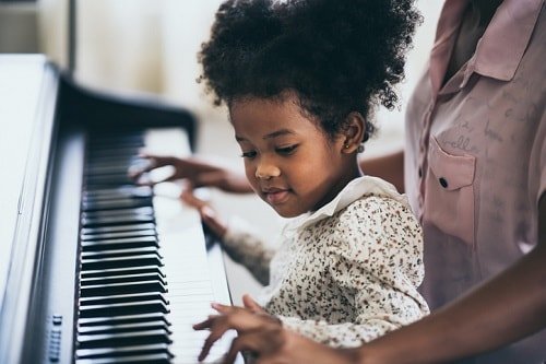 young girl plays the piano