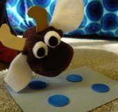 Cow puppet looking at a set of poker chips